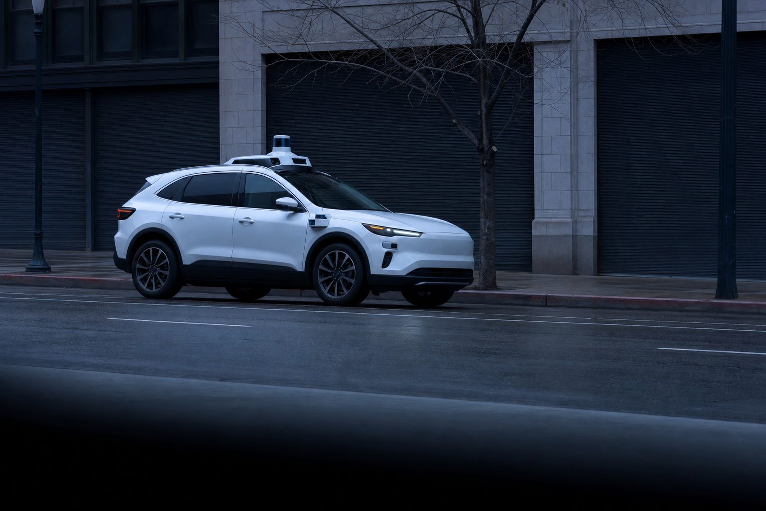 Unbranded driverless taxi with roof and side sensor pods waiting at a city kerb at dawn